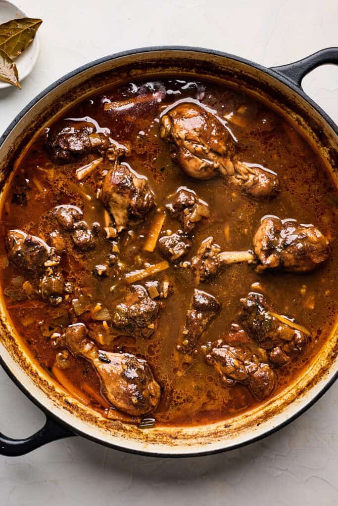 Brown stew chicken in a large pot