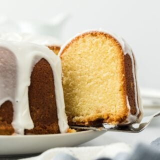 Close up of a slice of million dollar pound cake being pulled out of the cake with a cake server