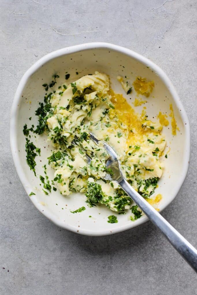 Mixed herb butter in a white bowl