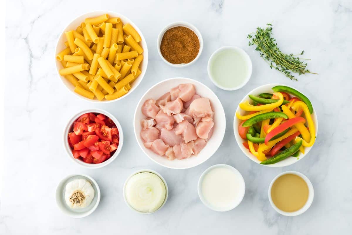 Overhead shot of ingredients to make rasta pasta on a white surface before cooking