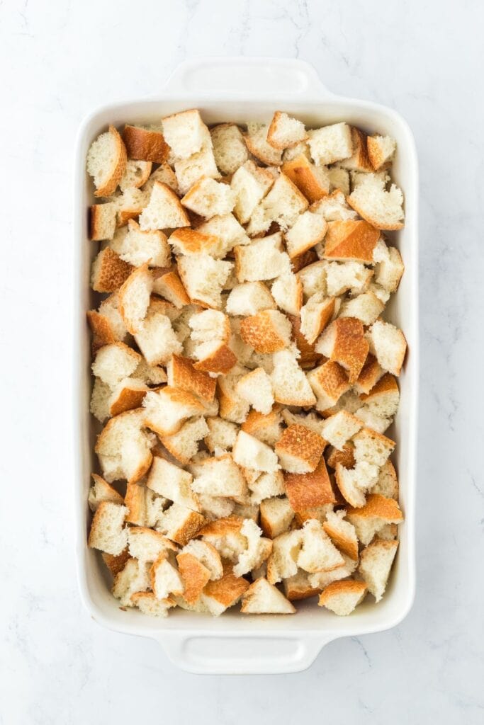 Torn pieces of bread in a casserole dish