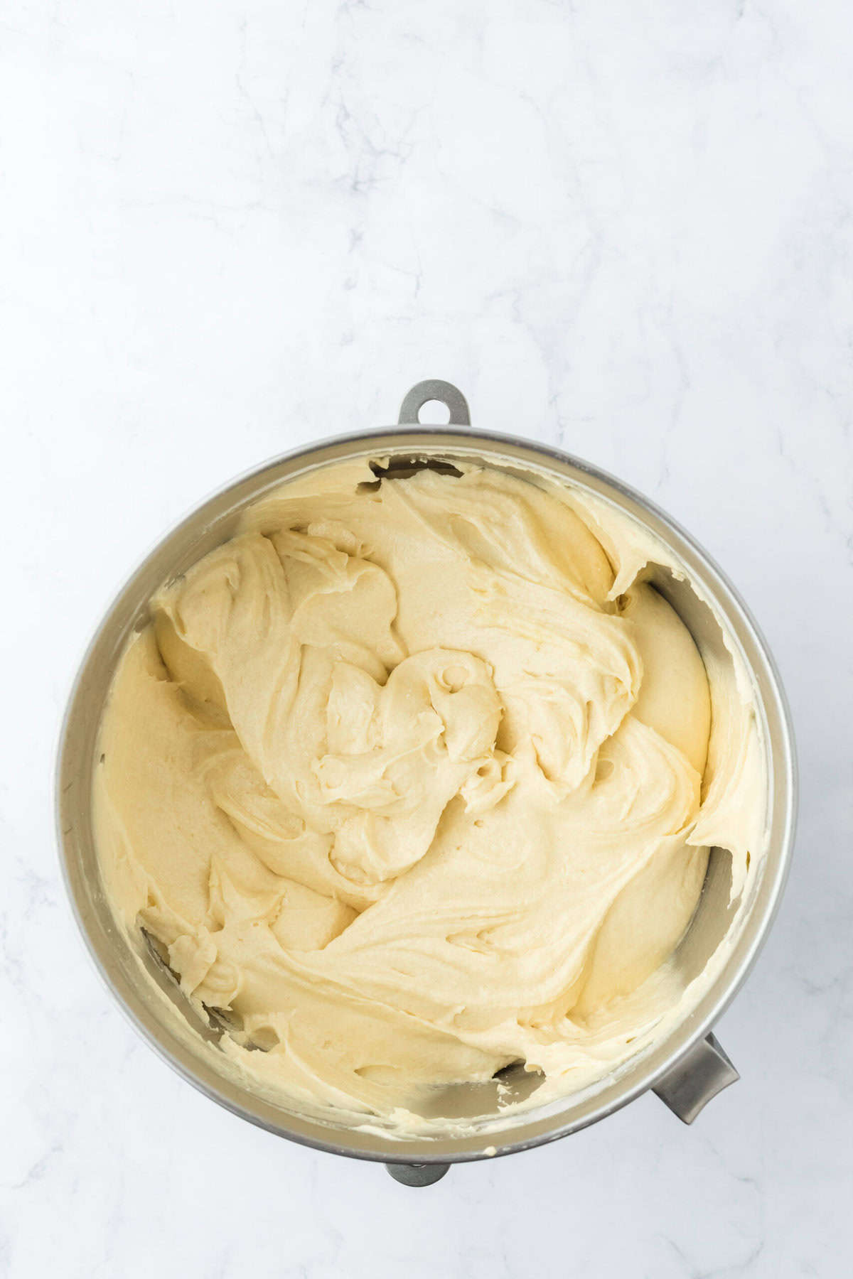 Creamed pound cake batter ready just before baking on white countertop