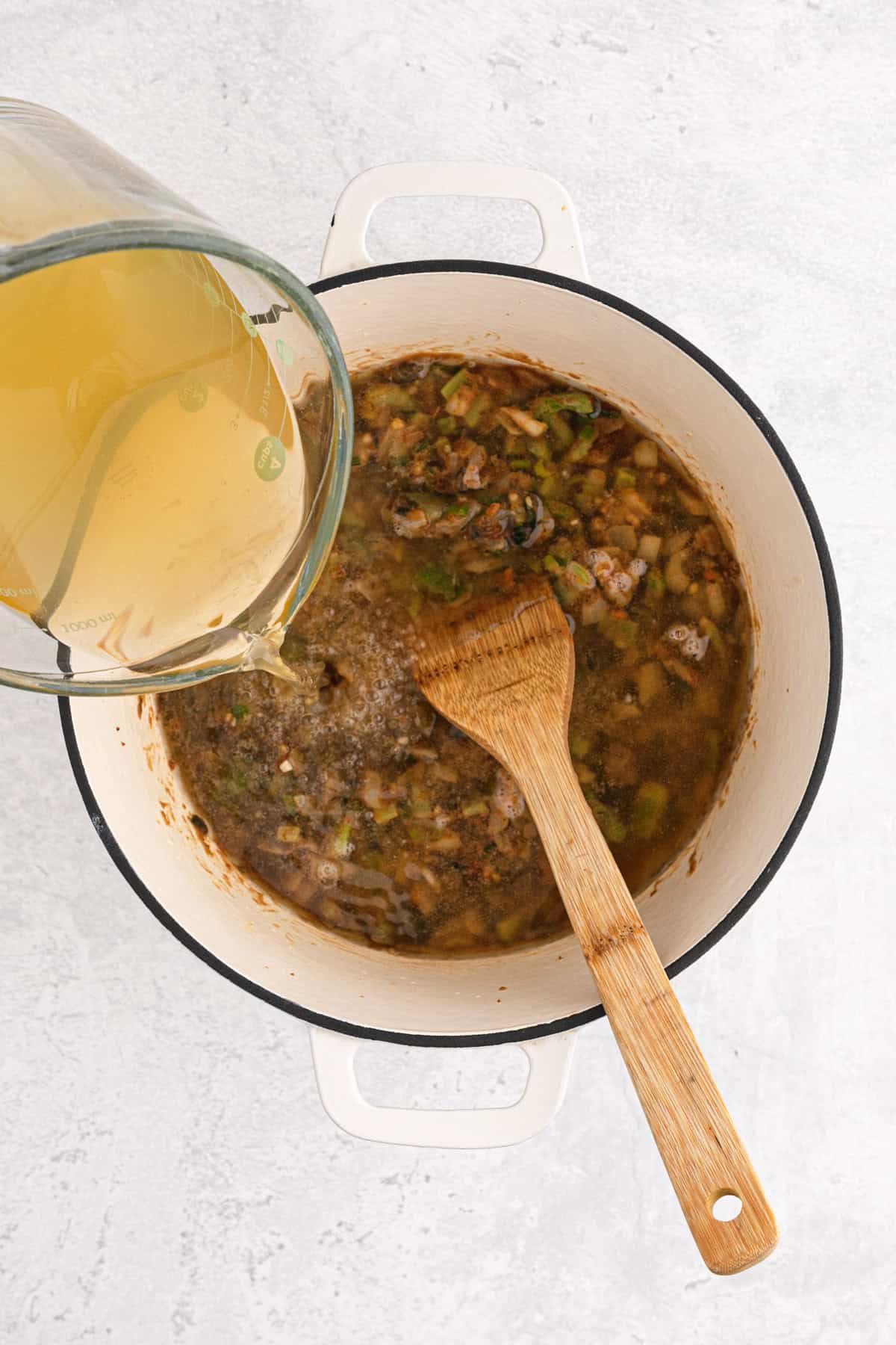 Broth added to a pot of gumbo cooking