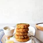 A stack of salmon croquettes on a white plate ready to serve