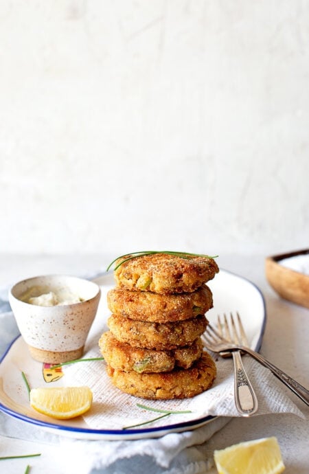 A stack of salmon croquettes on a white plate ready to serve