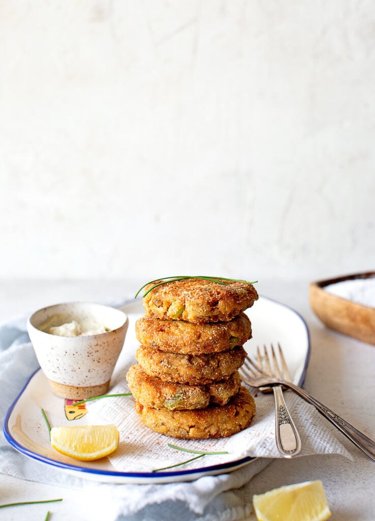 A stack of salmon croquettes on a white plate ready to serve