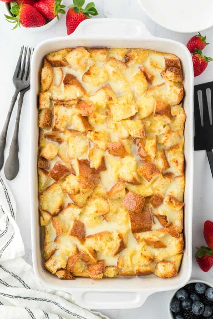 Baked white chocolate bread pudding with white chocolate sauce on the top