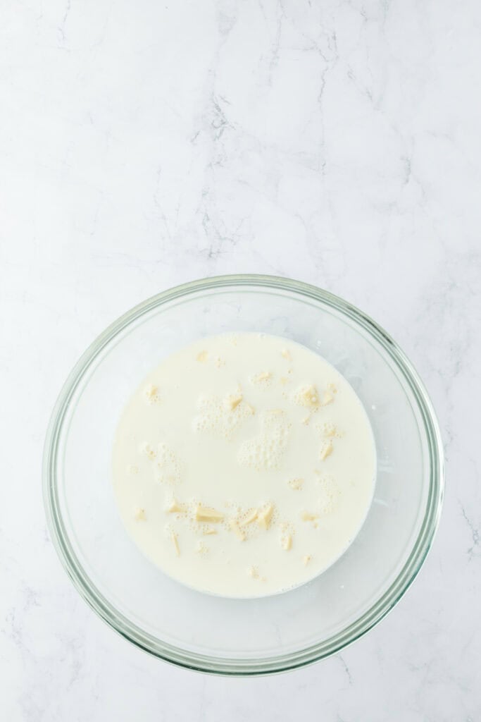Milk in a glass bowl with white chocolate