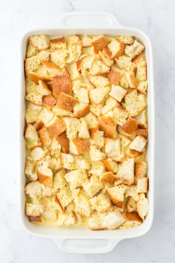 Custard poured over a casserole filled with bread cubes