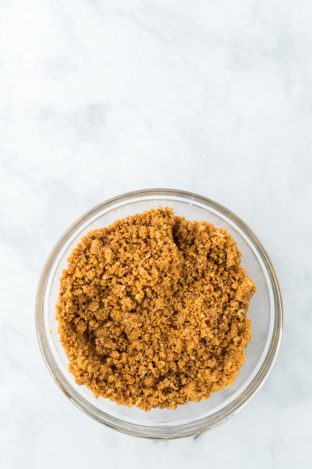 Pecan graham cracker crumbs in a clear bowl