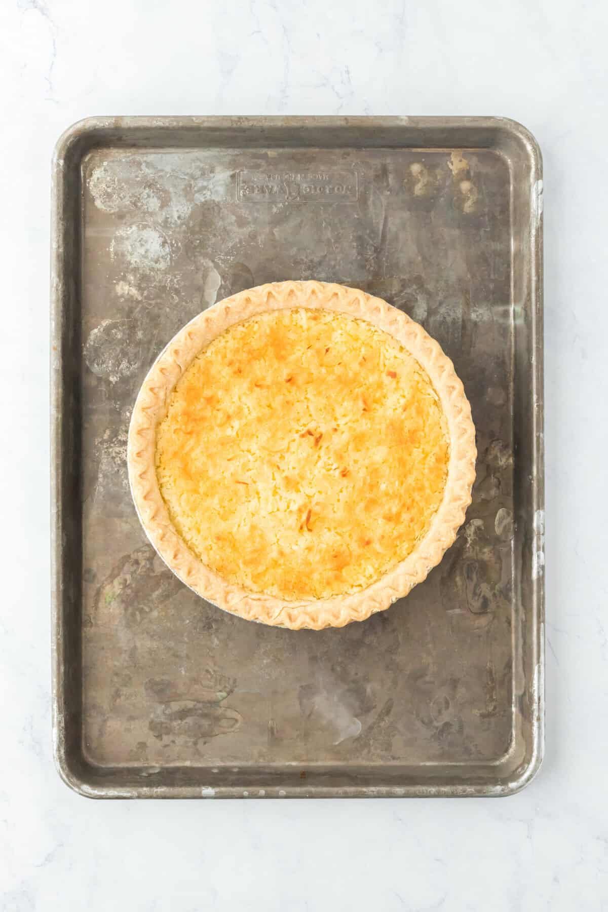 Baked coconut egg custard pie on sheet pan.