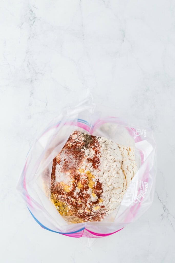 Spices in cornmeal and flour in a ziptop bag
