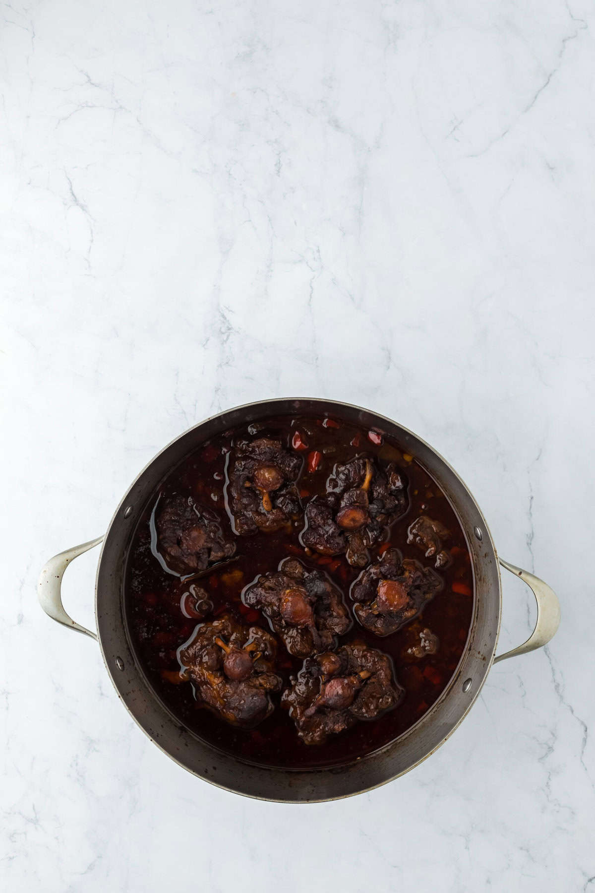 Tender oxtails in a sauce until thickened and ready to serve