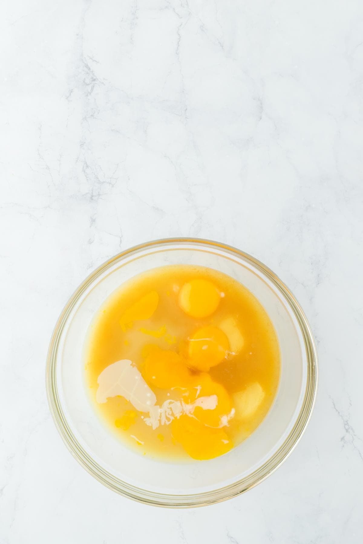 A bowl with eggs, juice, and other liquid filling ingredients