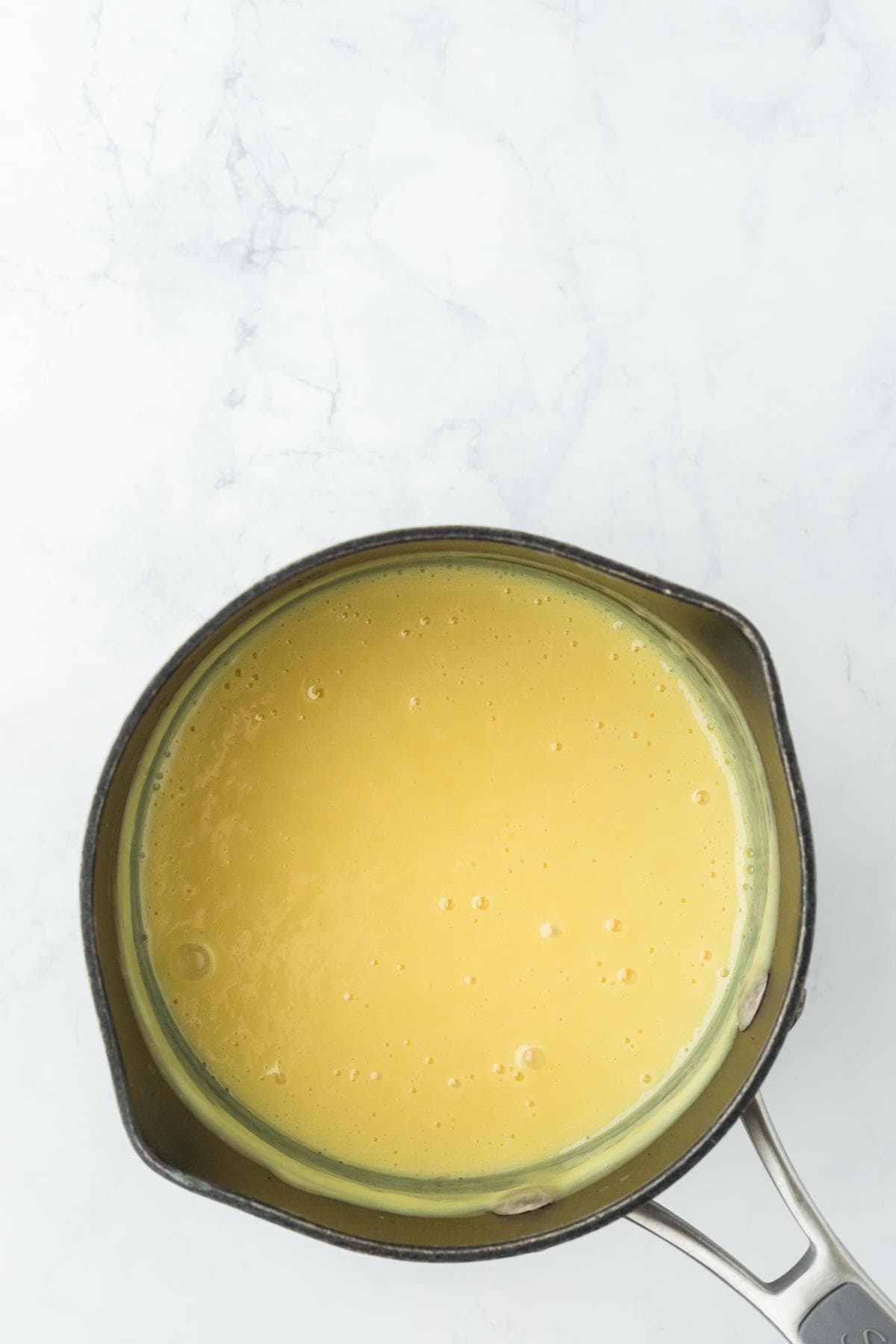 A saucepan filled with the creamy key lime filling
