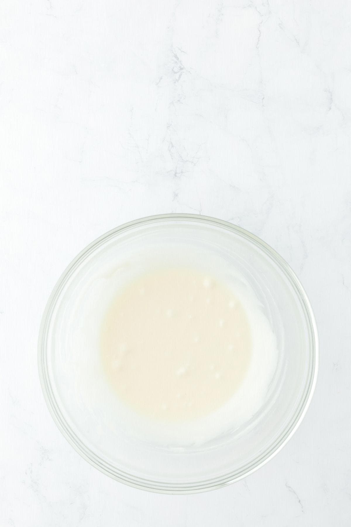 Simple pineapple glaze in bowl for pound cake topping