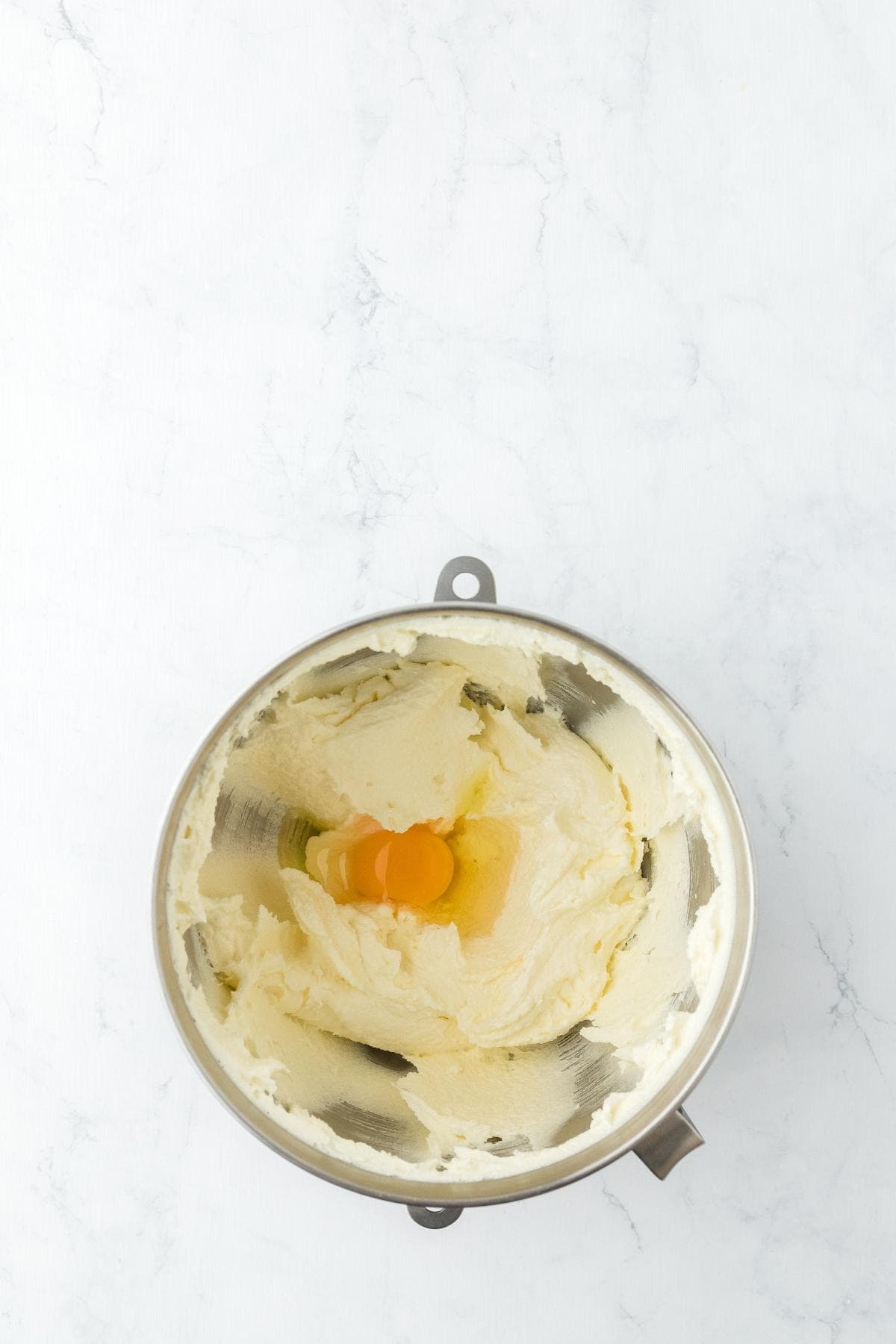 Creamed butter mixture with egg in mixer bowl