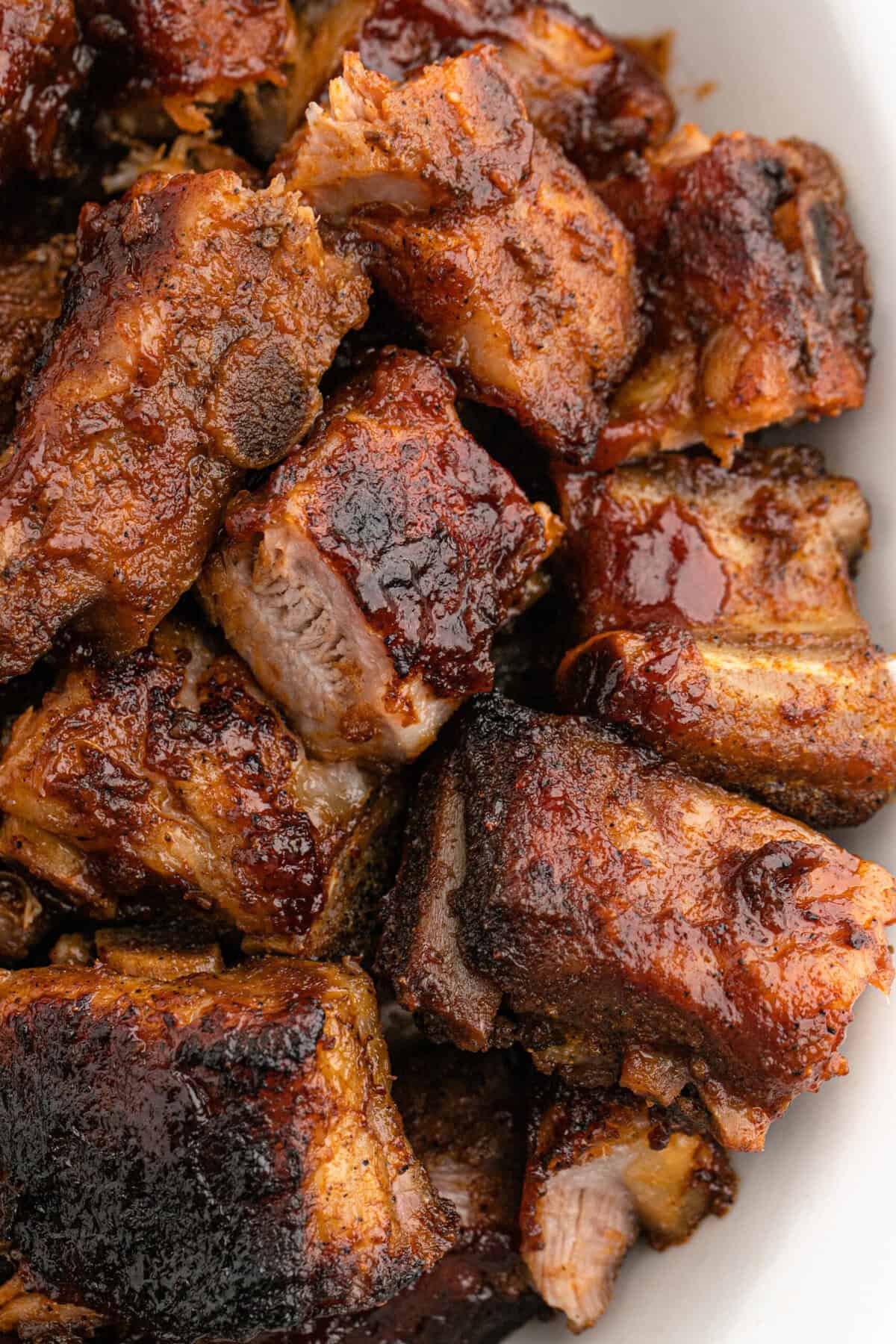 A close up of a bbq pork rib tip recipe on a white platter ready to serve