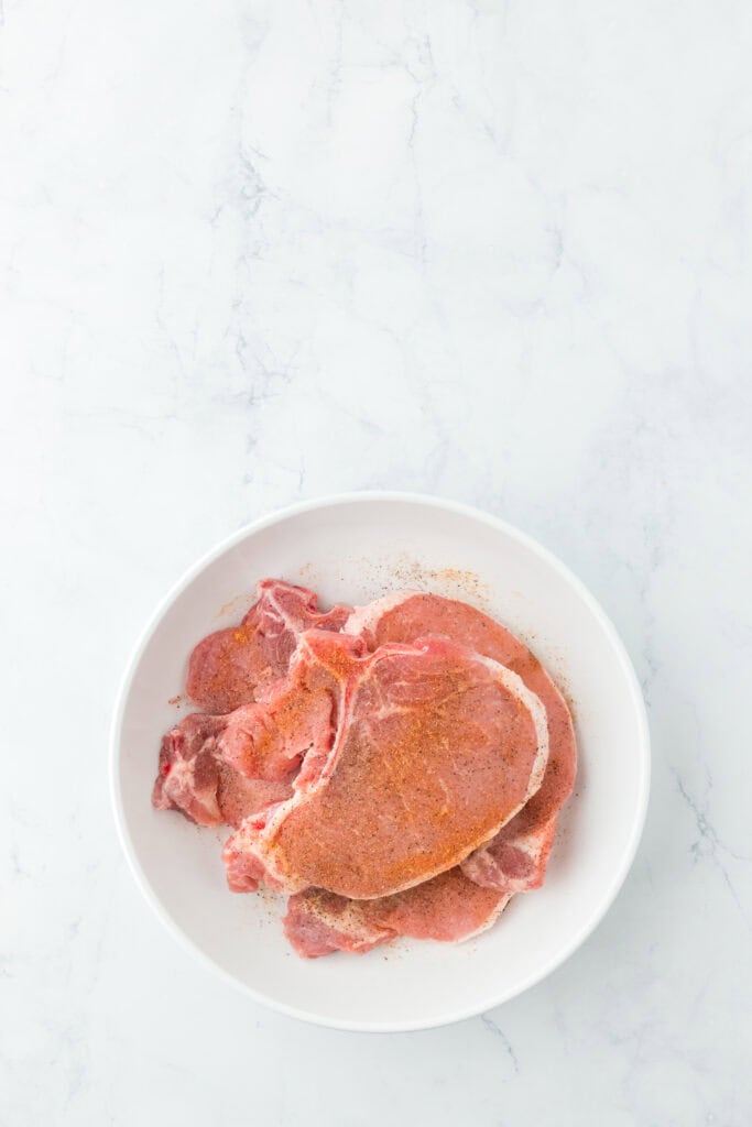 Seasoned pork chops on a white plate