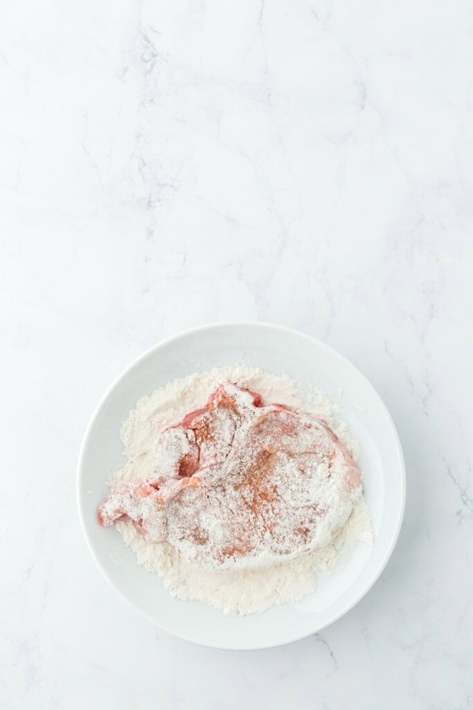 Dredged pork chops on a white plate