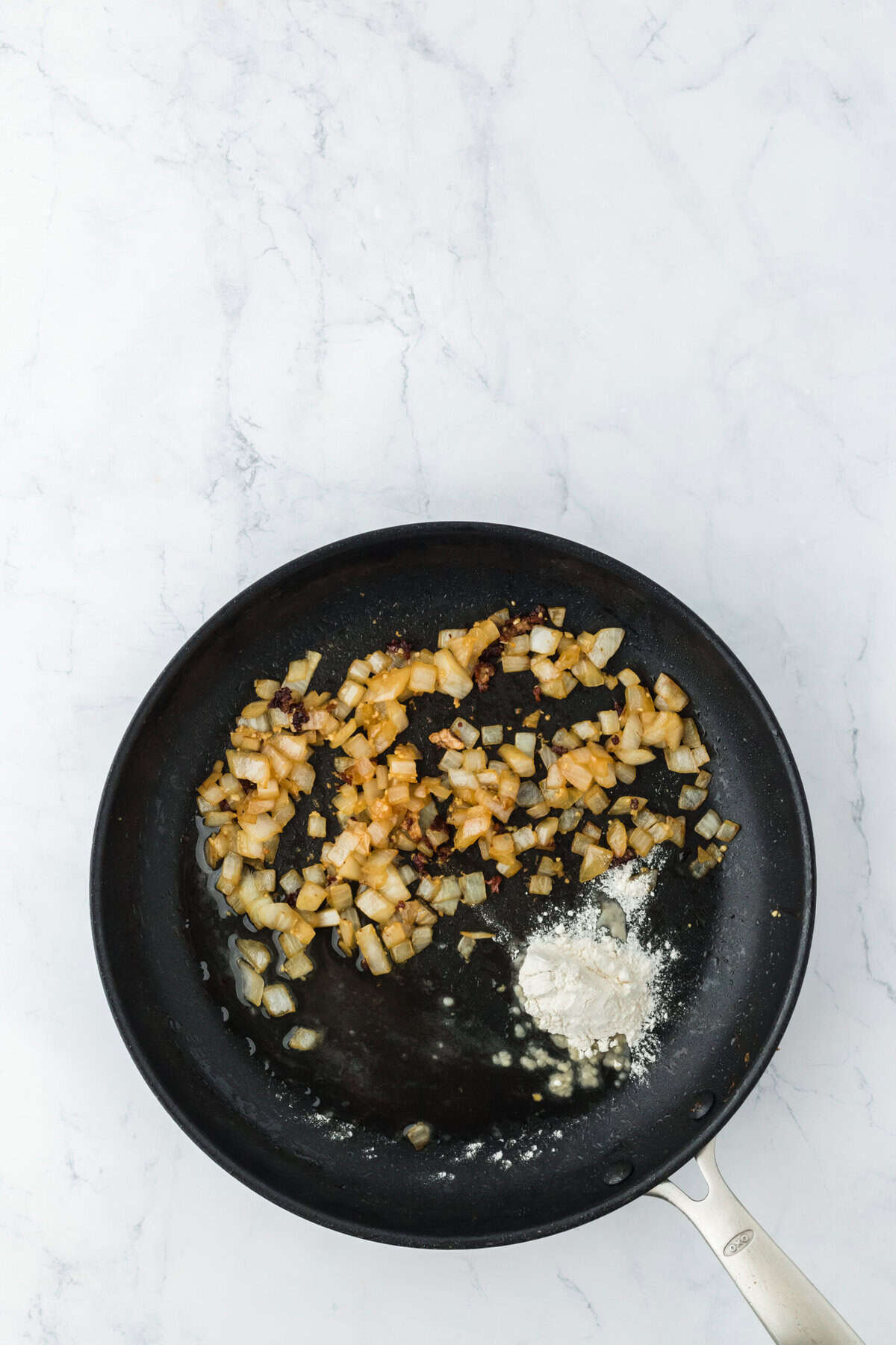 Flour added to skillet with onions and garlic