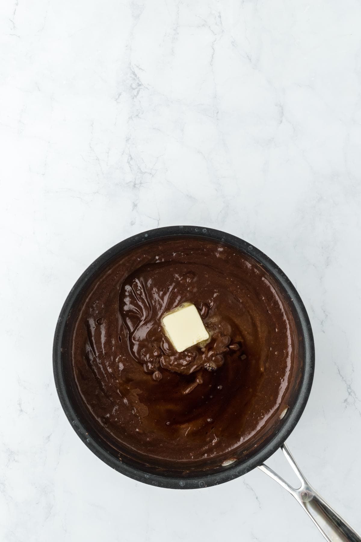 Thickened chocolate filling with a pat of butter melting in the center