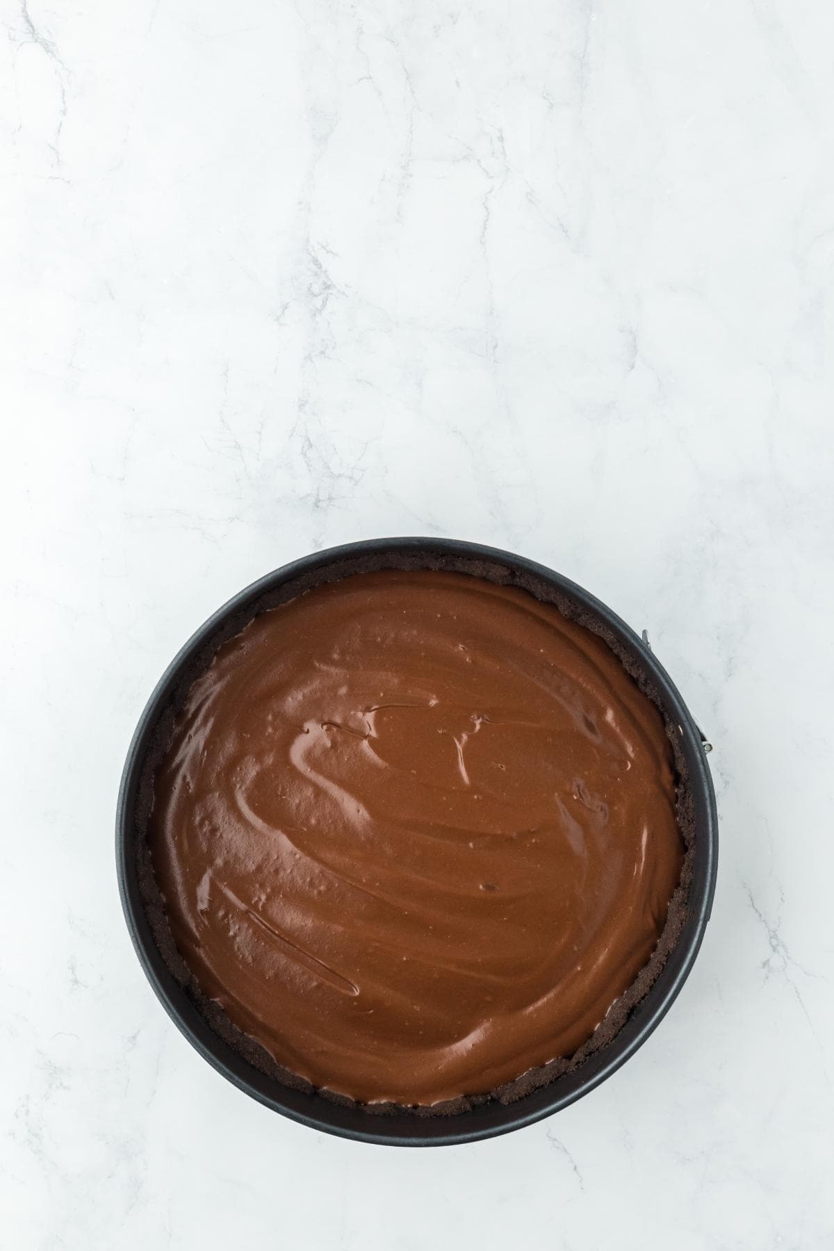 Chocolate pie filling smoothed into the Oreo crust after chilling