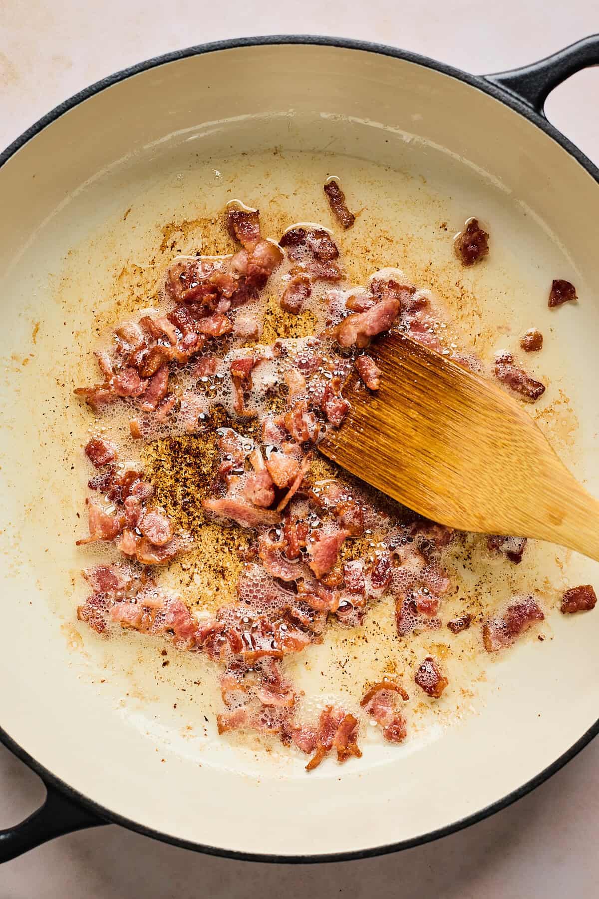 Bacon cooking in a large pot until crispy