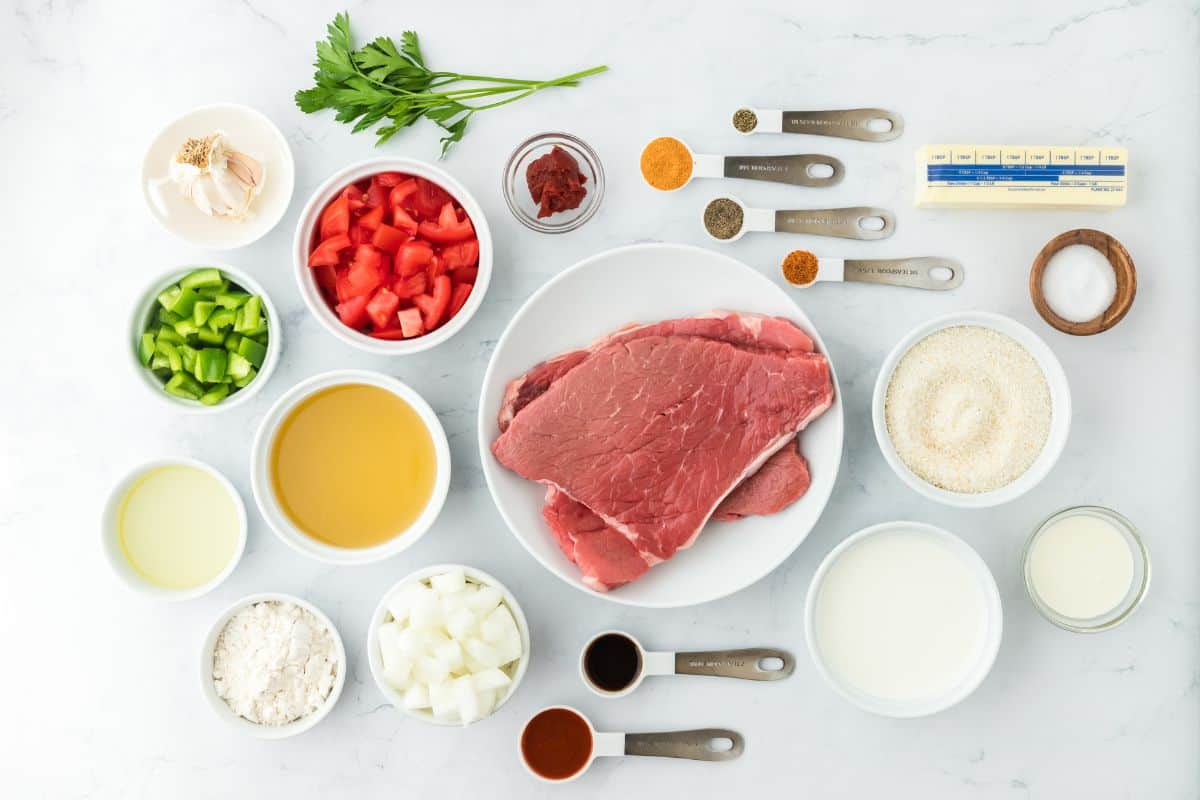 Overhead shot of ingredients to make grillades and grits on the table before cooking