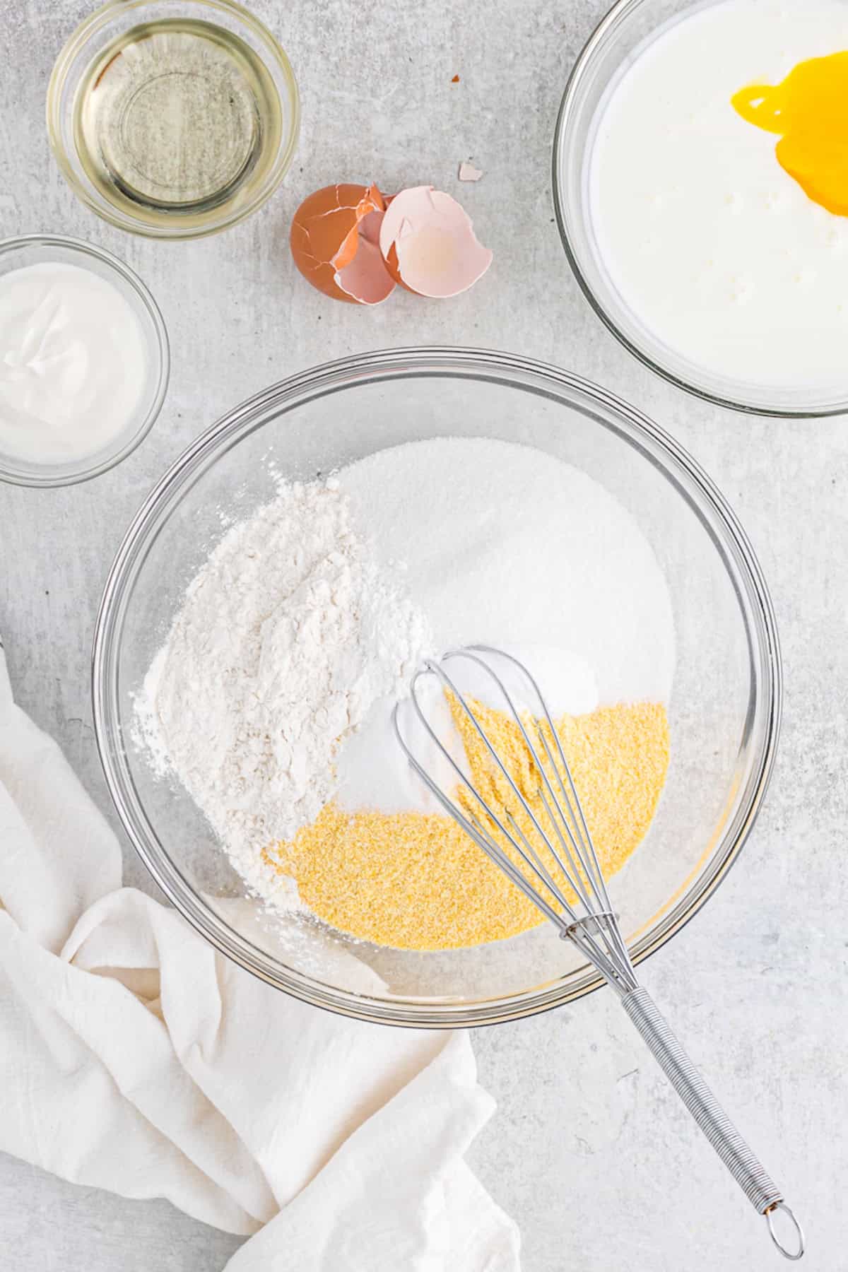 Dry ingredients being mixed in a large glass bowl