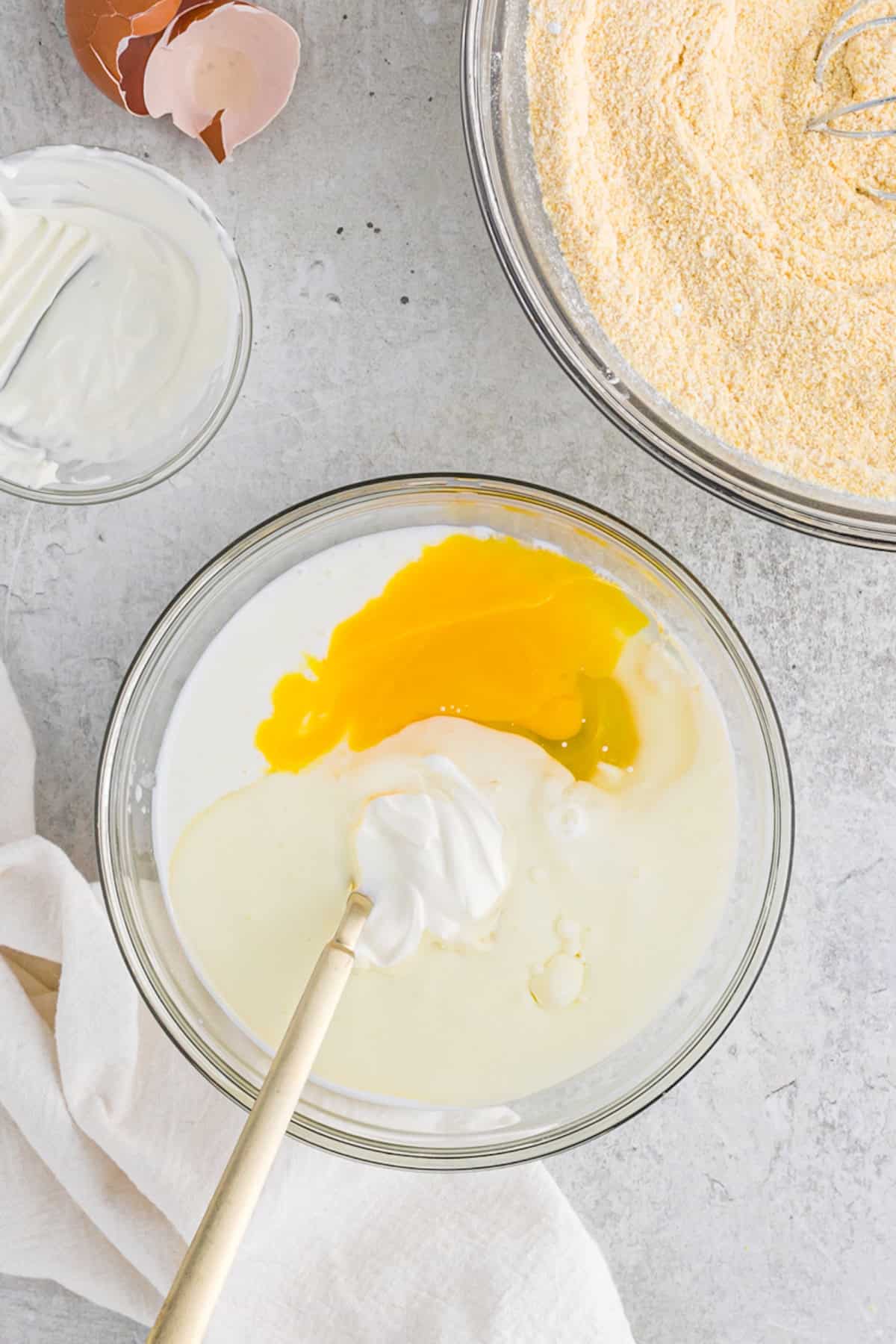 Wet ingredients being mixed in a glass bowl