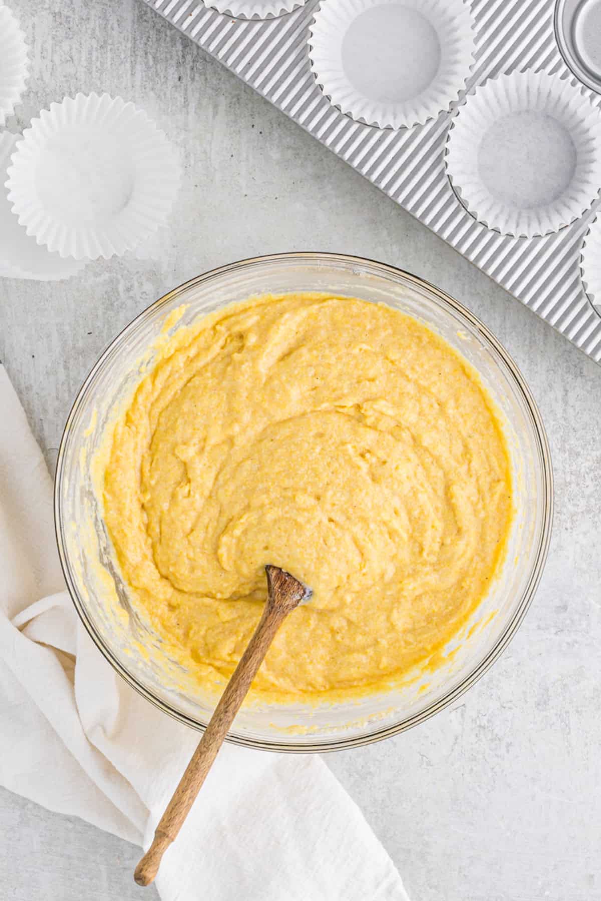 Mixed jiffy cornbread batter in a glass bowl on countertop