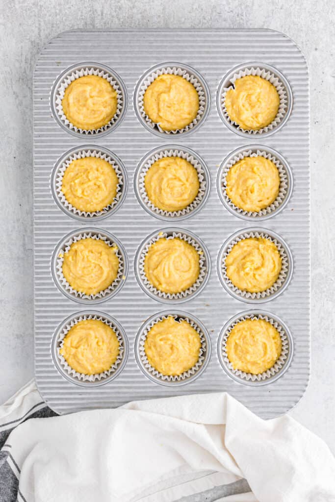 Cornbread batter added to muffin tins prior to baking