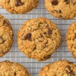 Overhead shot of baked oatmeal chocolate chip cookies cooling on a wire rack