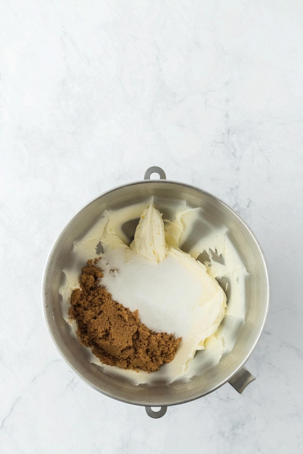 Butter, brown sugar, and granulated sugar in a stand mixer bowl before mixing
