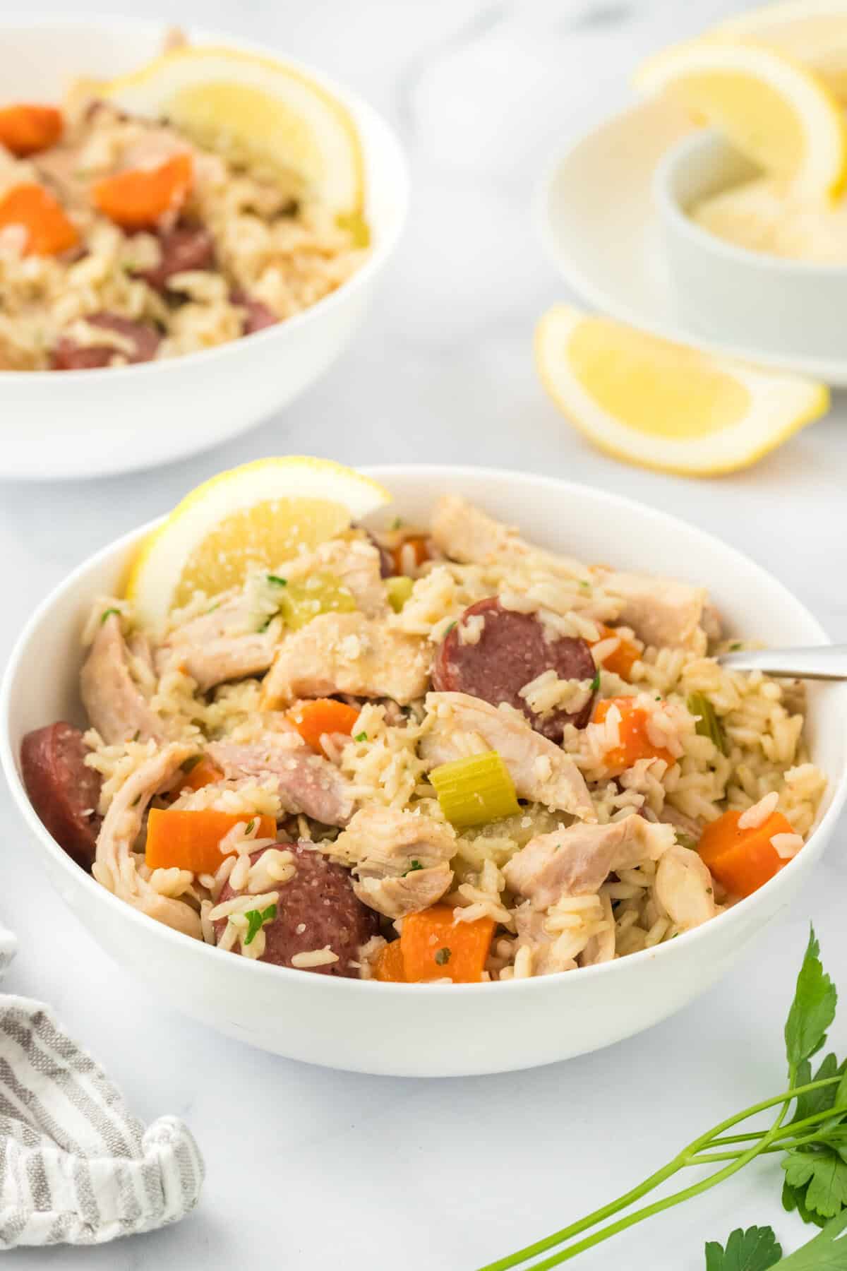 A classic Southern chicken bog recipe in a white bowl with another bowl in white background