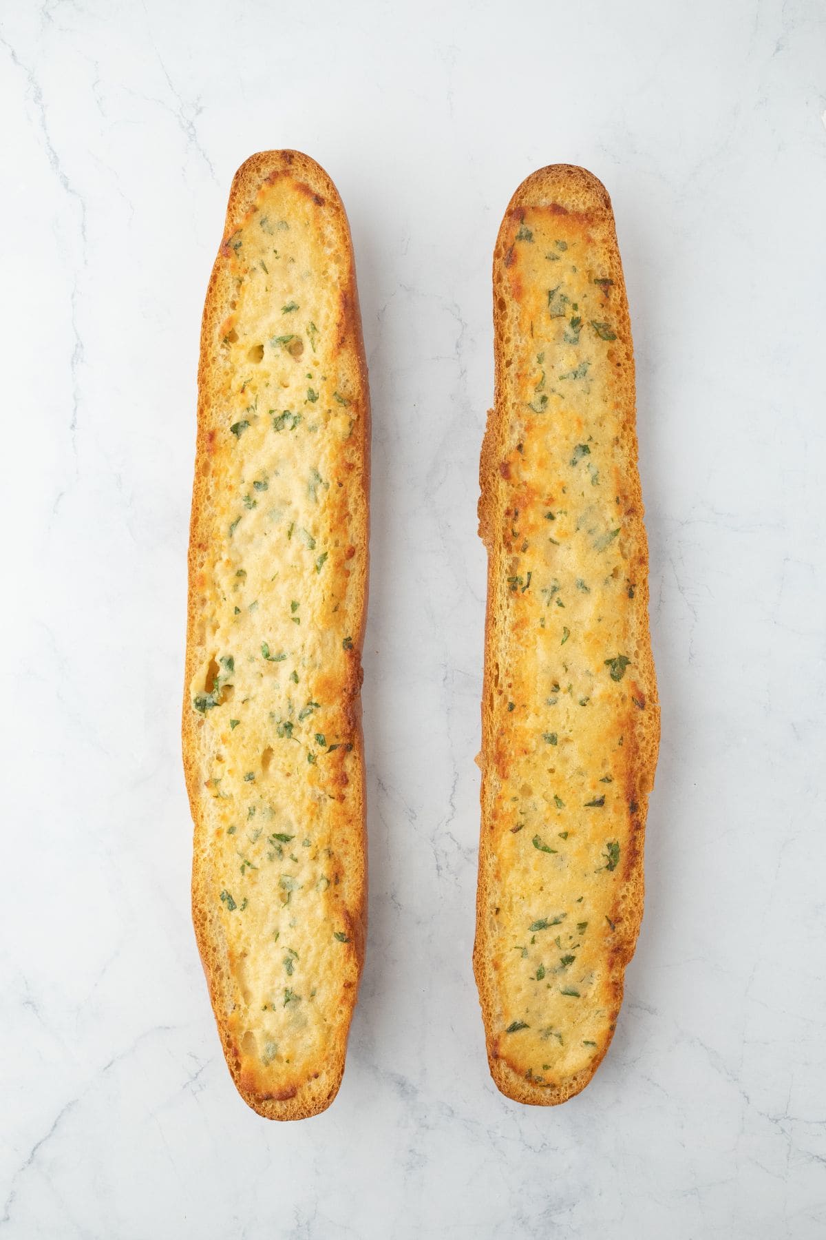 The bread halves after being baked, golden and crispy on top