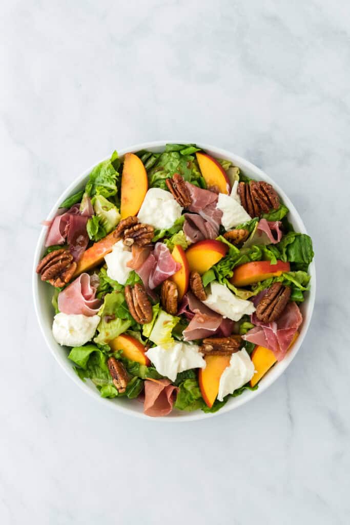Finished peach salad with burrata added on top