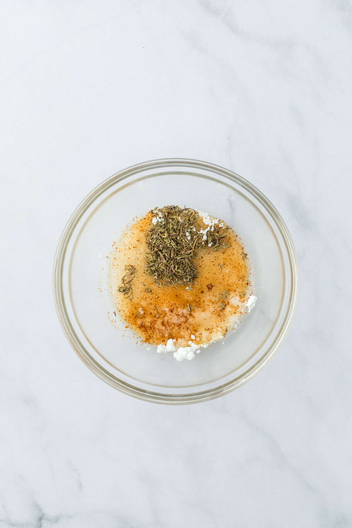 Candied pecan ingredients in a clear bowl on a white background