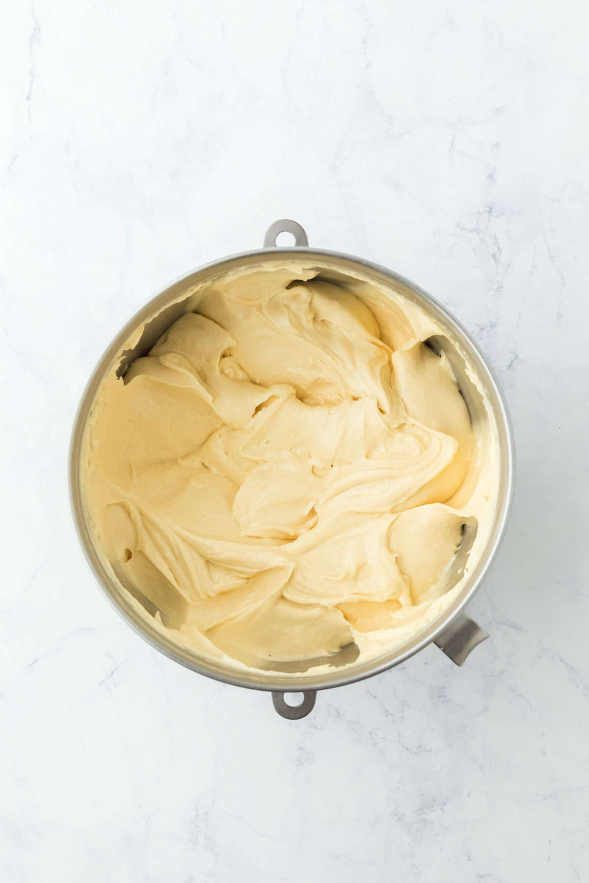 Perfectly mixed sock it to me cake batter in stand mixer bowl on white background