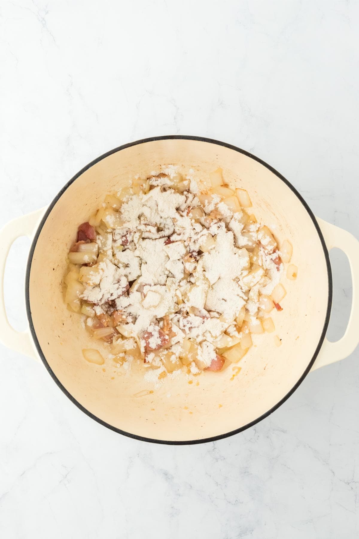Flour sprinkled over cooked onions and bacon to create a thickening base