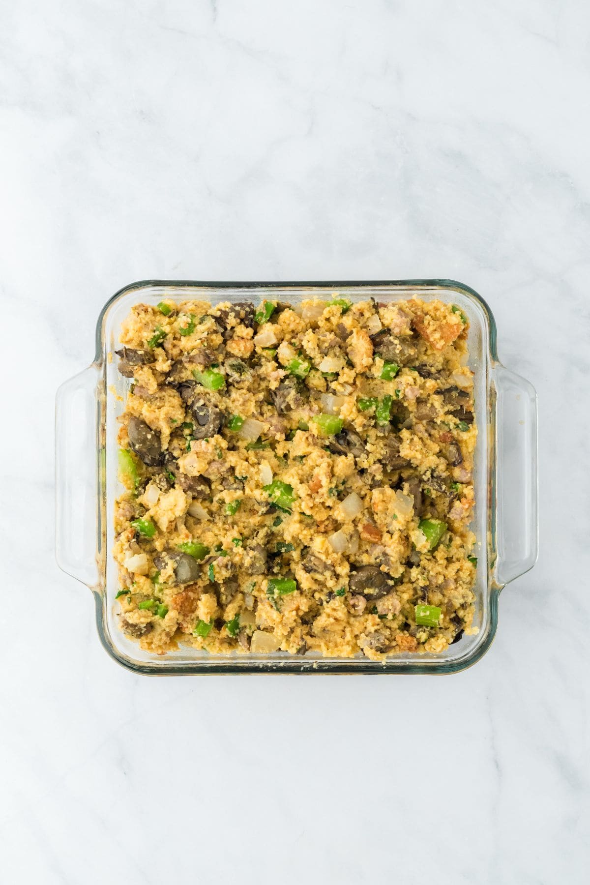 Oyster dressing in a glass baking dish before baking