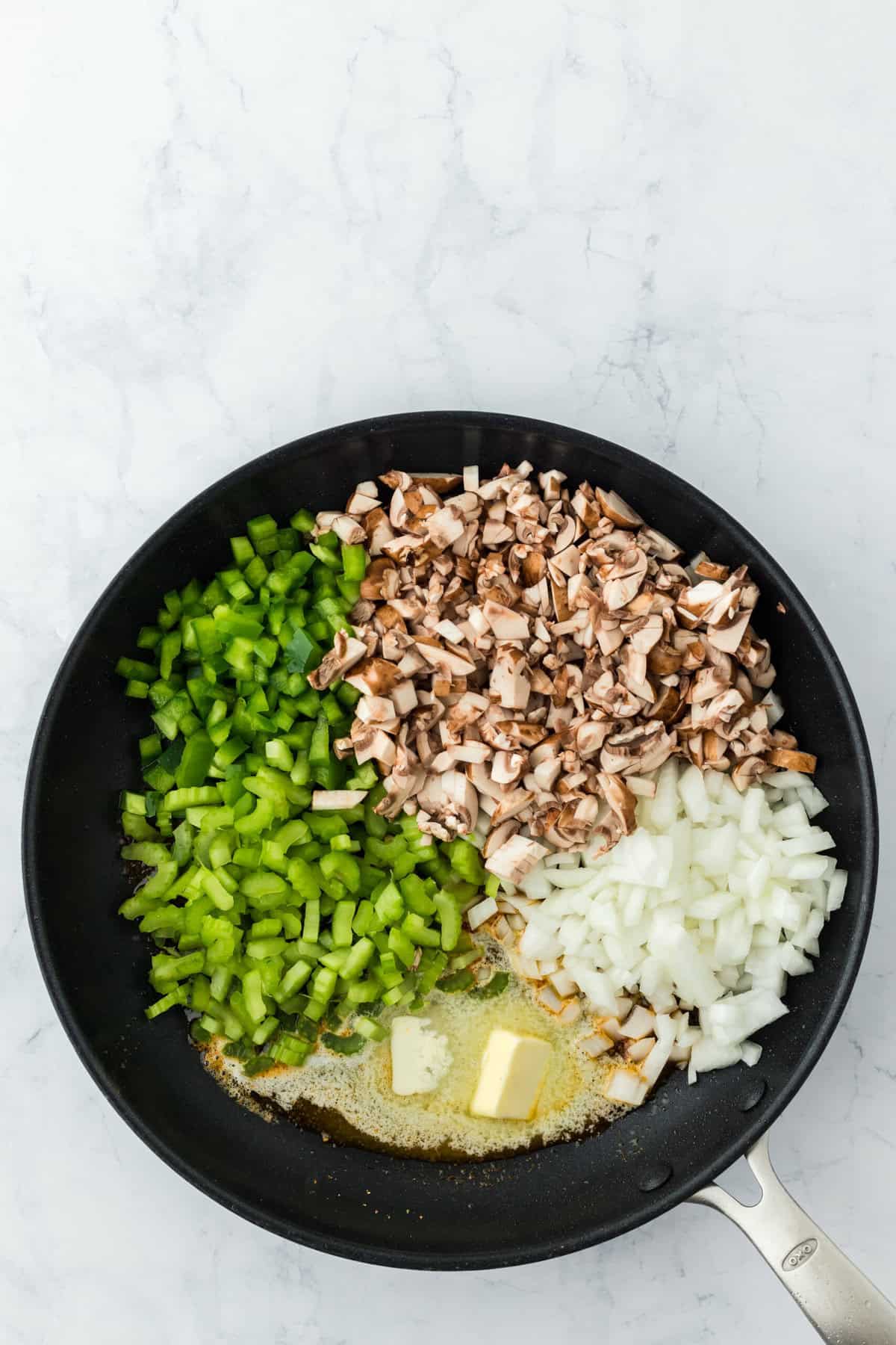 raw mushrooms, onions, celery, green peppers and butter in a skillet for pork chop casserole