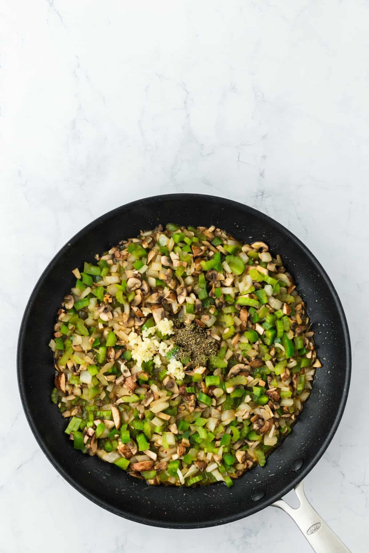 softened mushrooms, onions, celery, green bell peppers in a skillet