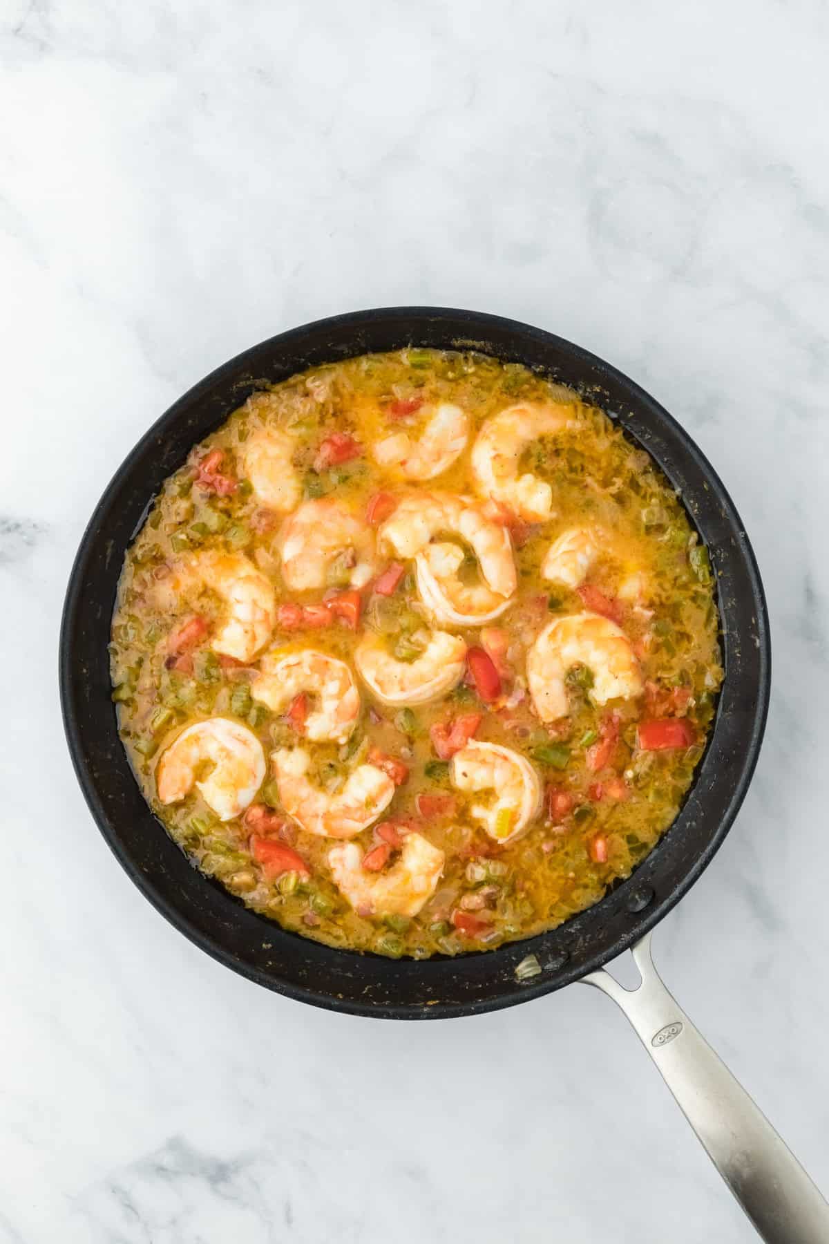 Cooked shrimp in a sauce until translucent before adding to grits.