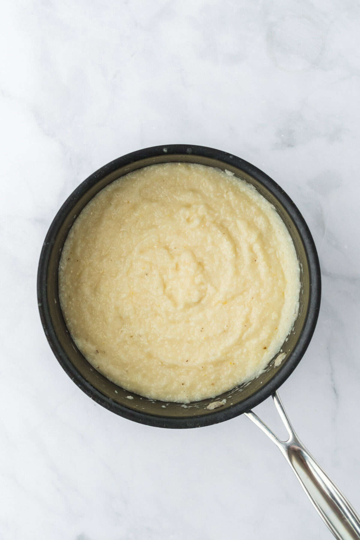 A pot of cooked buttery grits ready to serve