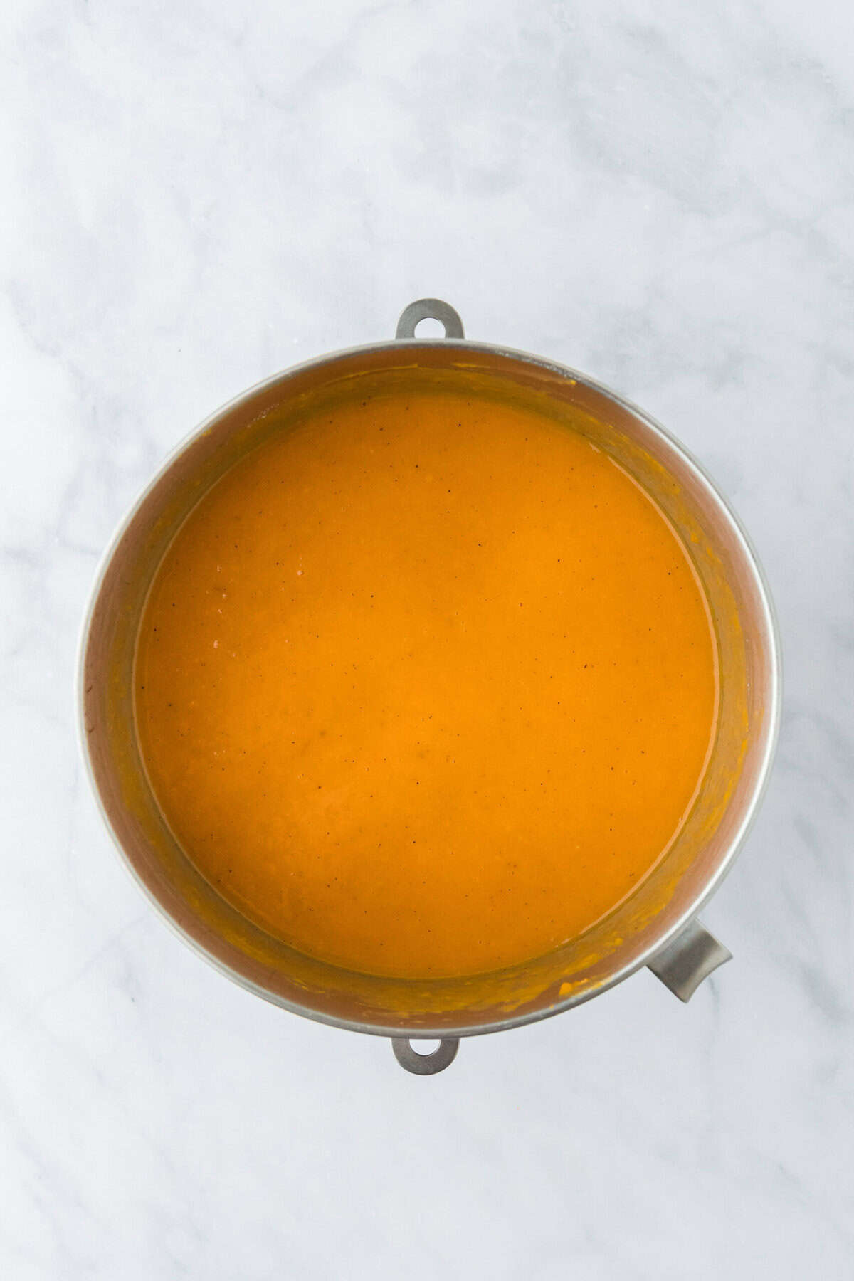 Sweet potato pie filling in a stand mixer bowl on white countertop