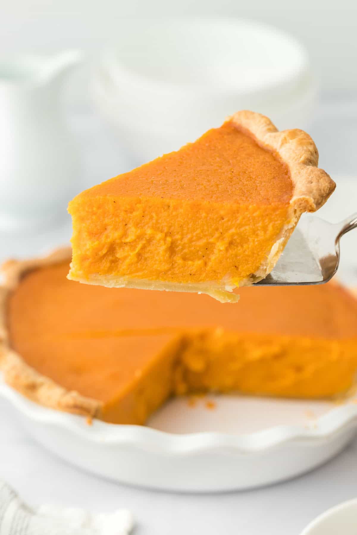 A slice of the best sweet potato pie recipe on a spatula serving