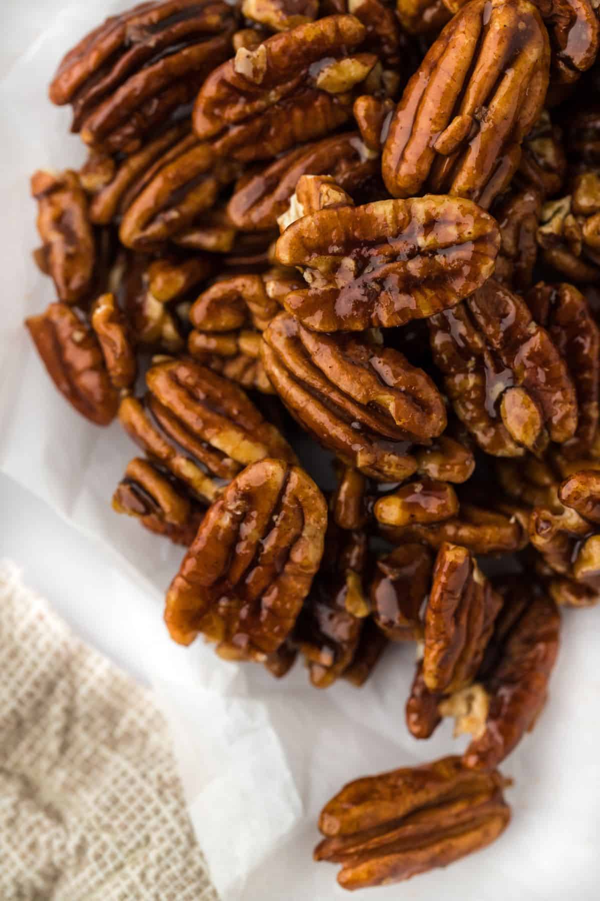 Candied pecans arranged on parchment paper