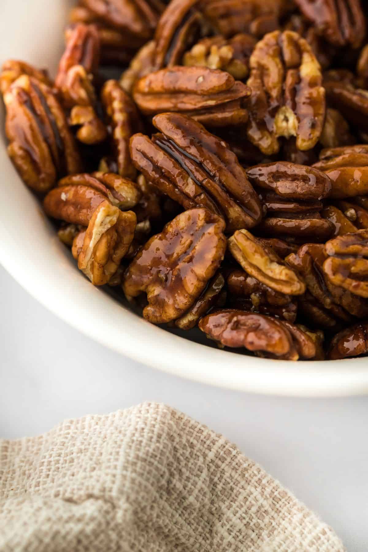 Candied pecans on a white bowl